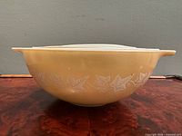 Side view of largest tan bowl showing Sandalwood Ivy leaf pattern