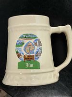Front view of ceramic beer stein mug showing Acadia National Park graphic and name "Jim"