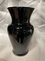 Full view of glossy black vase showing shape and finish