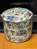 Full view of stacked container showing all three tiers and decoration