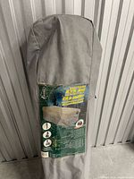 Gray carry bag standing upright with product label visible