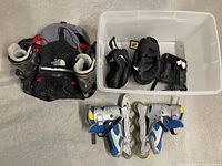 Backpack, pads in bin, both skate pairs overview