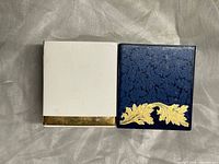 Front view of both tissue box covers showing exterior designs