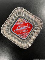 Top view of clear glass ashtray showing Lamb's Ice Cream logo insert