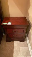 Front view of nightstand showing drawers and hardware