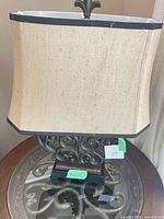 Full view of lamp showing shade, base, scroll design