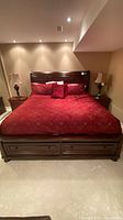 Front view of assembled king sleigh bed with red bedding