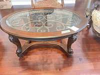 Full view of oval glass-top coffee table