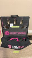 Overall view of BodyBoss platform, carrying bag, resistance band and mat