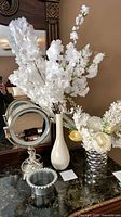 Mirror, two vases with faux flowers, pewter bowl grouped together