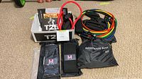 Overall lot showing T25 box, resistance tubes, fabric band and bags