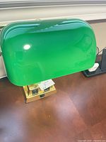 Full view of green glass shade illuminated