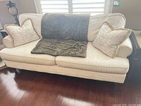 Front view of sofa with pillows and throws