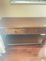 Front view showing drawers, shelf, overall style