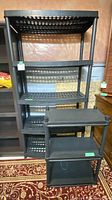 Large five-tier black plastic shelving and smaller unit in front