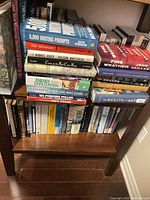 Two shelves filled with assorted books, titles and spines visible