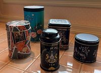 Group shot of all five tins showing variety of shapes, sizes and designs