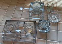 All five glass items arranged on tile countertop