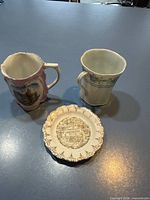 Overall view of two mugs and Washington souvenir plate
