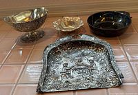 Group shot of all four metal tableware pieces