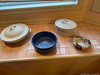 Group shot of tureen, blue bowl, butter crock, ashtray