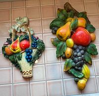 Both chalkware fruit plaques side by side