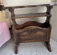 Front view of one wood side table showing shelf and magazine rack compartment