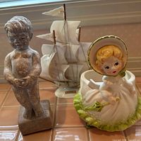 Group shot of horn sailboat, Relpo planter, Manneken Pis statue