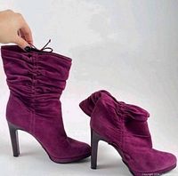 Full side view of both boots showing color, heel height, and ruched shafts