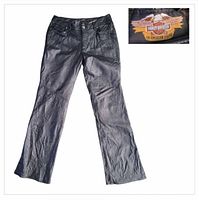 Full view of black leather Harley-Davidson pants laid flat