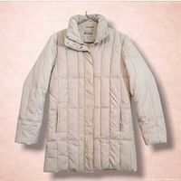 Front view of beige quilted puffer coat on hanger