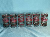 Six matching highball glasses in a row showing full design