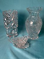 Group image showing Orrefors vase with label, matching small creamer, and additional cut glass vase