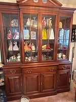 Full front view of china cabinet showing upper glass doors and lower storage
