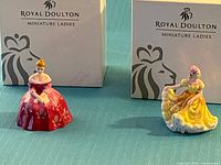 Both figurines with their original boxes