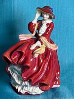 Front view of Royal Doulton Top O' The Hill figurine showing face, dress and petticoats