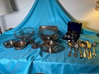 overview of all silver-plated items on blue cloth