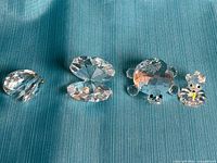 All three figurines arranged: closed clam shell, opened clam shell halves with pearl, turtle, mouse