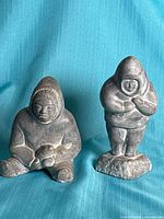 Front view of both soapstone Inuit figures
