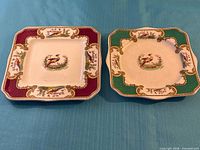 Both square Chelsea Bird plates, burgundy and green versions