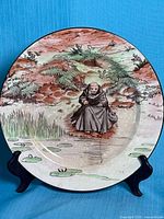Front view of Royal Doulton plate showing full monk fishing scene