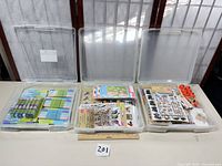 overview of three open plastic cases with craft contents