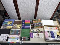 Overall view showing all nine cardstock and paper pads laid out on table