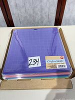 Box holding stack of assorted-color Crafter's Square 12 x 12 cutting pads