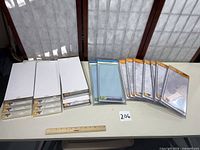 Full lot showing boxed sets on left and sealed single plates on right