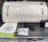 Front view of Cricut Expression machine with power adapter and booklet
