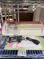 Front angled view of Cricut Expression with accessories on wire shelf