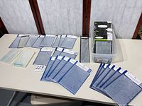 Table with entire assortment of embossing folders, tub of additional packs visible