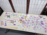 Overview of the 31 sealed card-making packs on table with ruler for scale