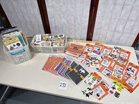 Entire lot on table: stamp packs, card sets, bins with wooden pieces and blocks